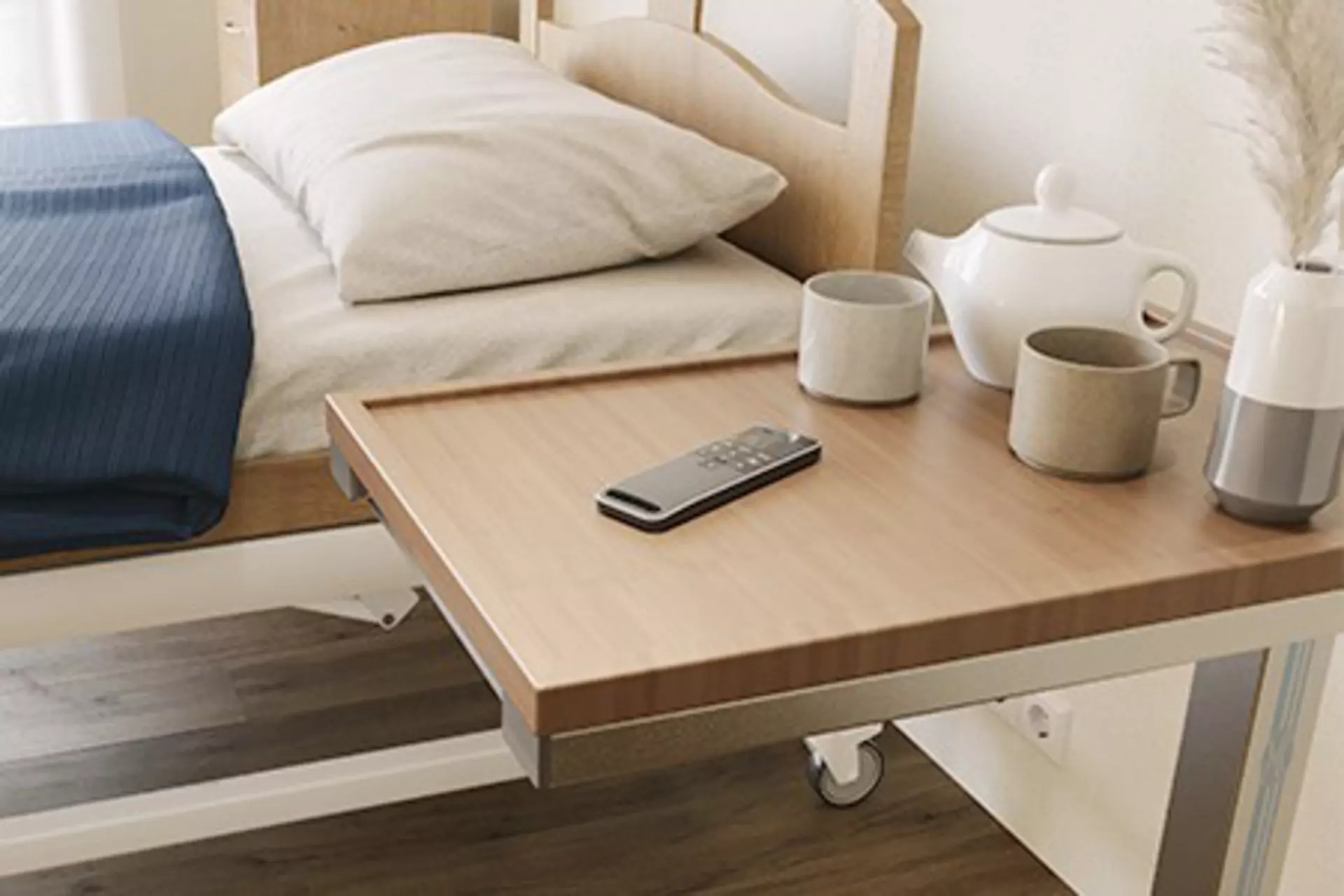 LINAK HC40 hand control placed on a bedside table, for homecare and nursing home beds.