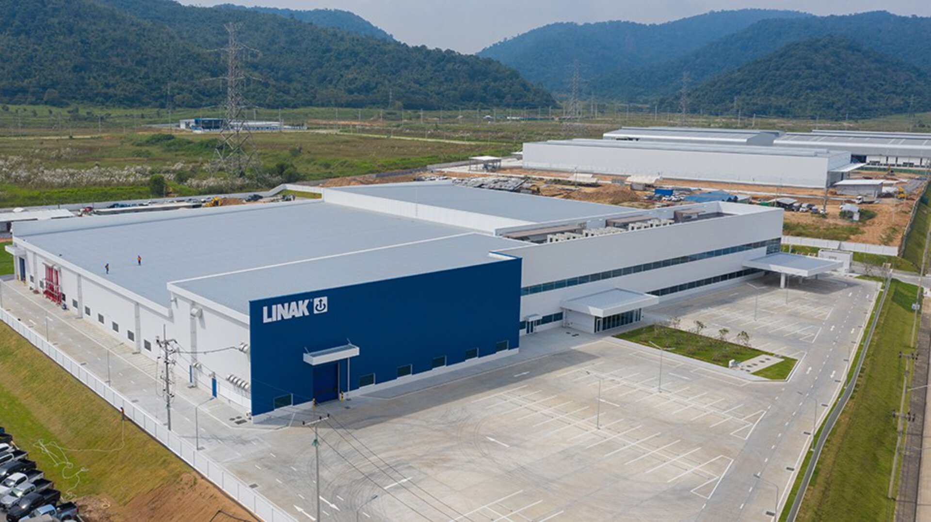 LINAK APAC - industrial facility with a blue warehouse building and additional production buildings behind it.