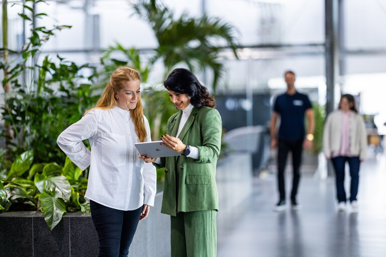 Two persons discussing project on the floor