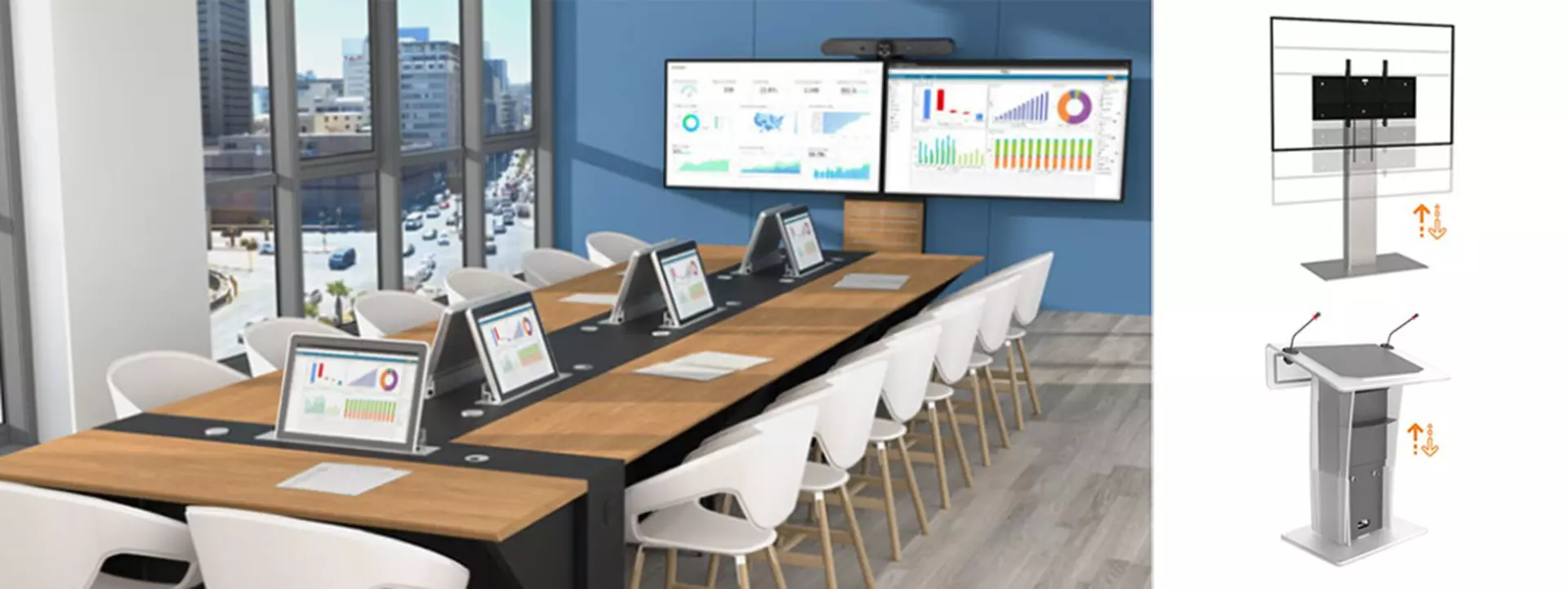 Large conference table with individual screens, white chairs, and an electric height adjustable dual screen monitor stand displaying charts and figures.