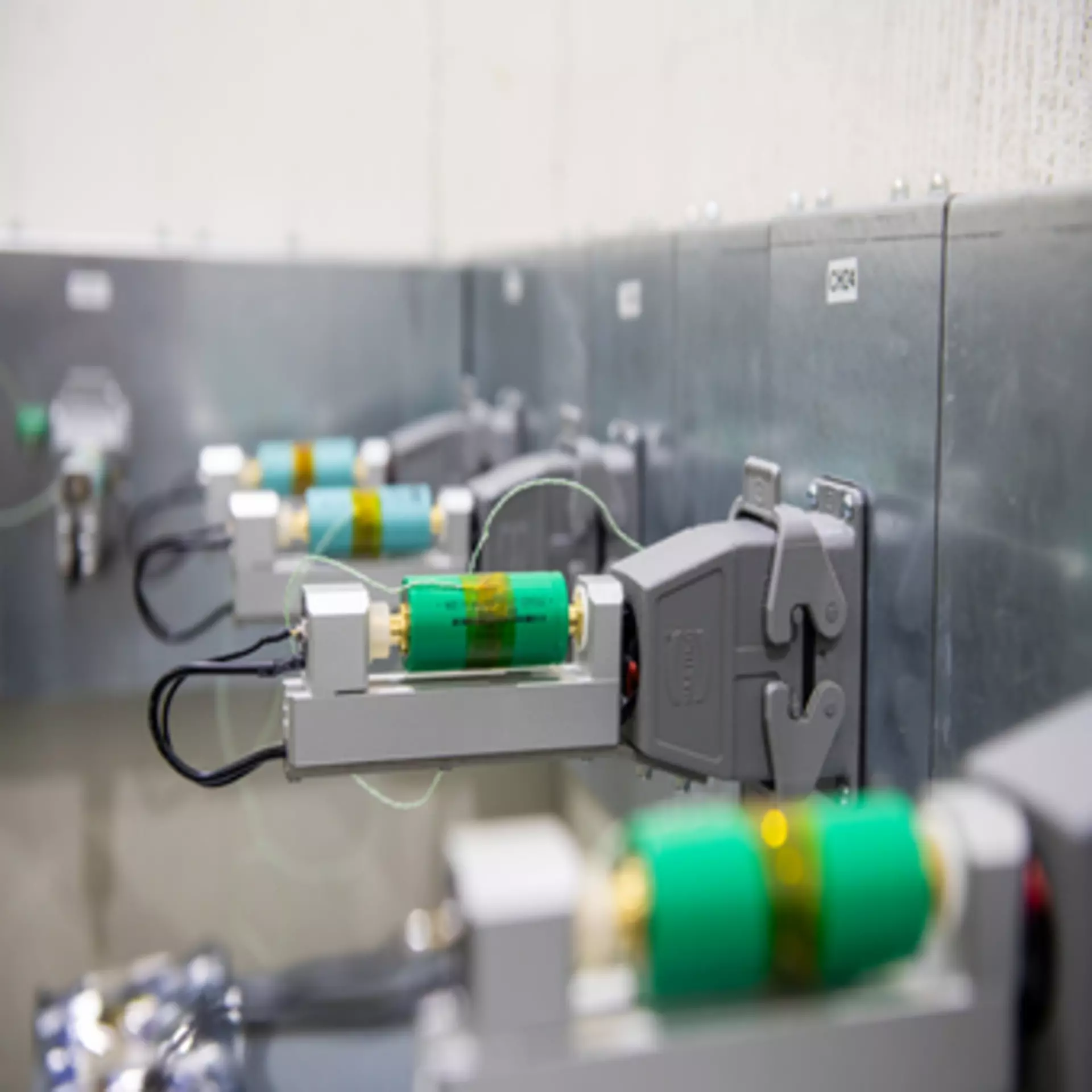 Set-up battery test facilities, several green batteries lined up for testing at LINAK.
