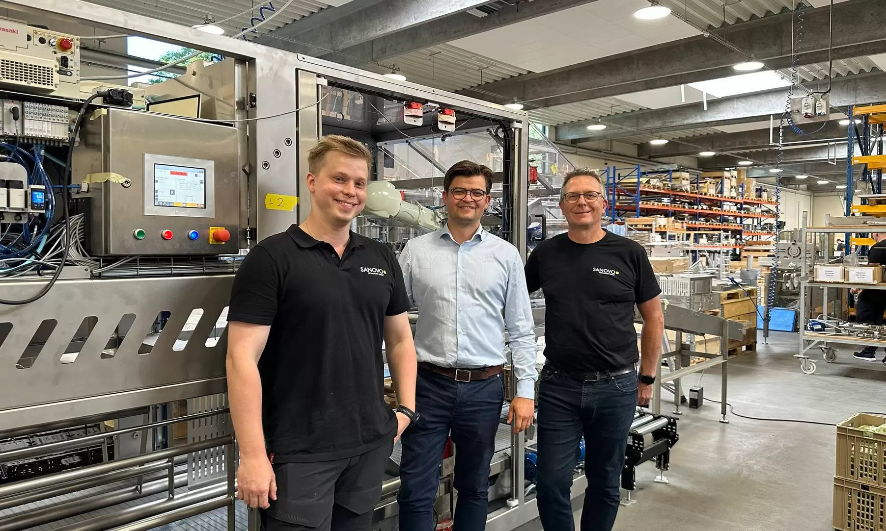 SANOVO Frank and Simon next to an egg packaging machine