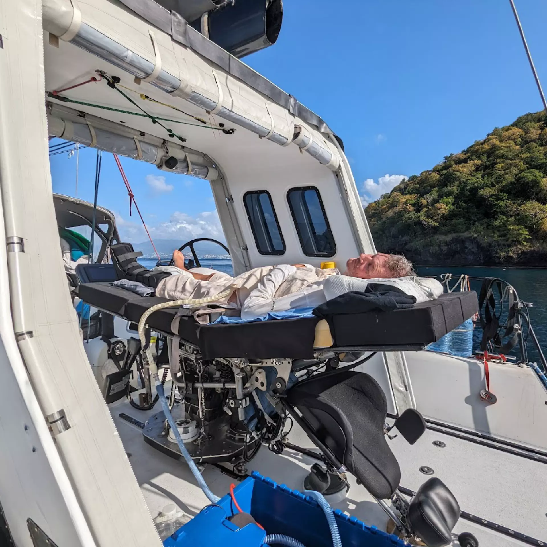 Anders Lehmann on a boat, lying on a console converted into a bed.