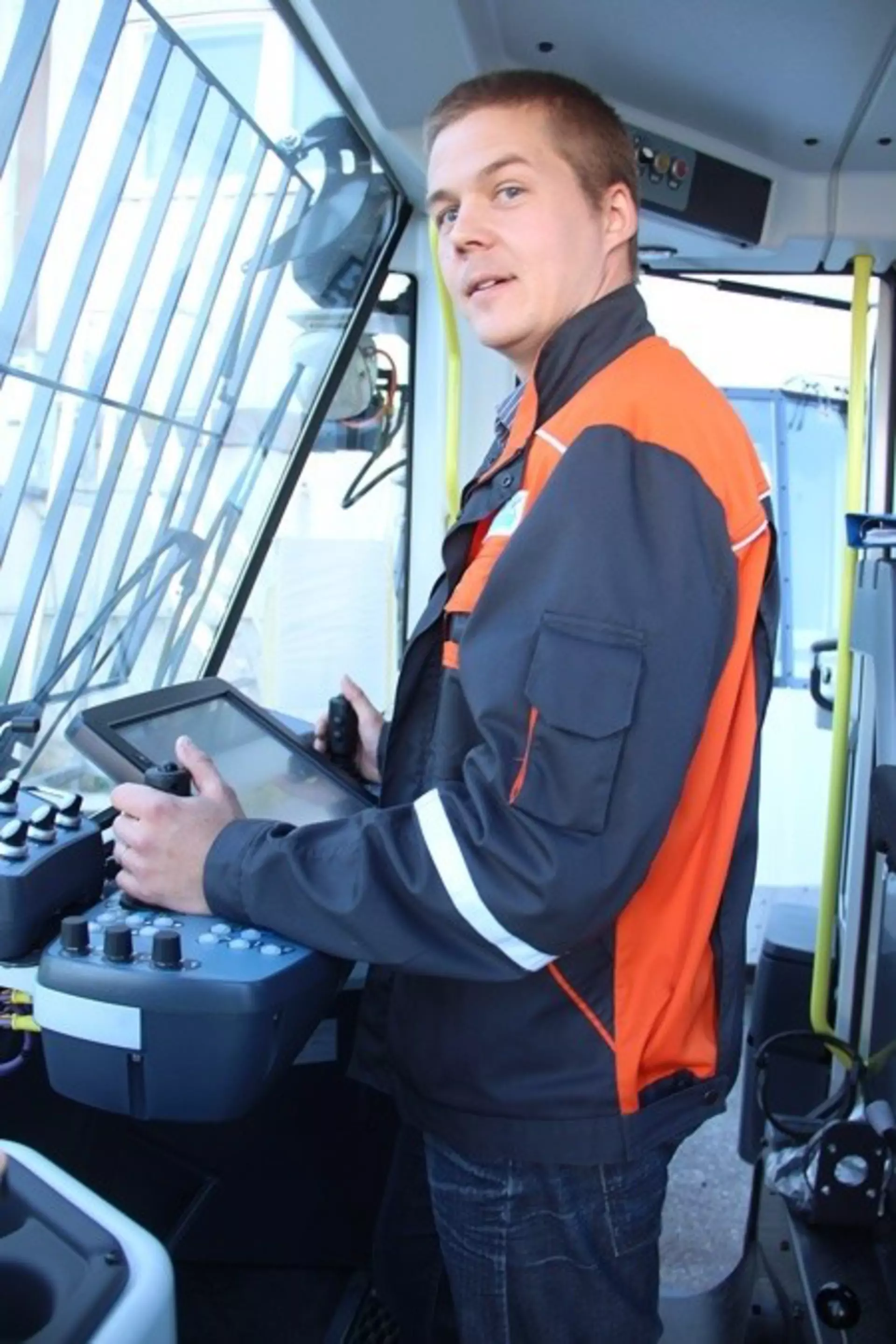 Mika Väisänen standing at the control panel