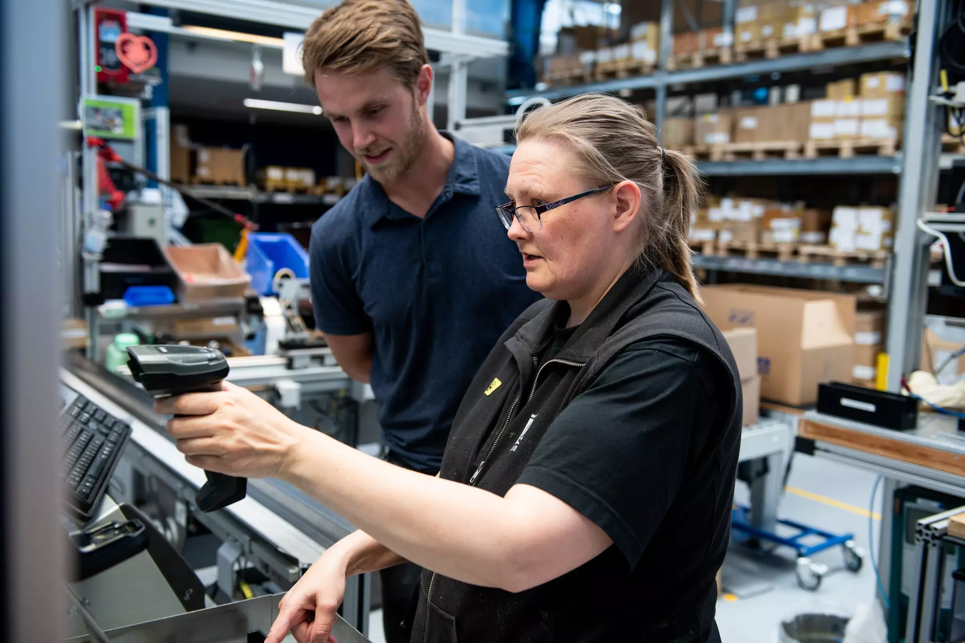 People collaborating around a machine at LINAK